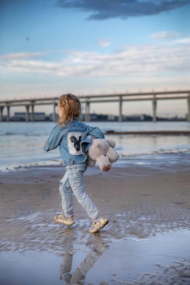 She jumped off the driftwood log, her sneakers landing with a crunch.